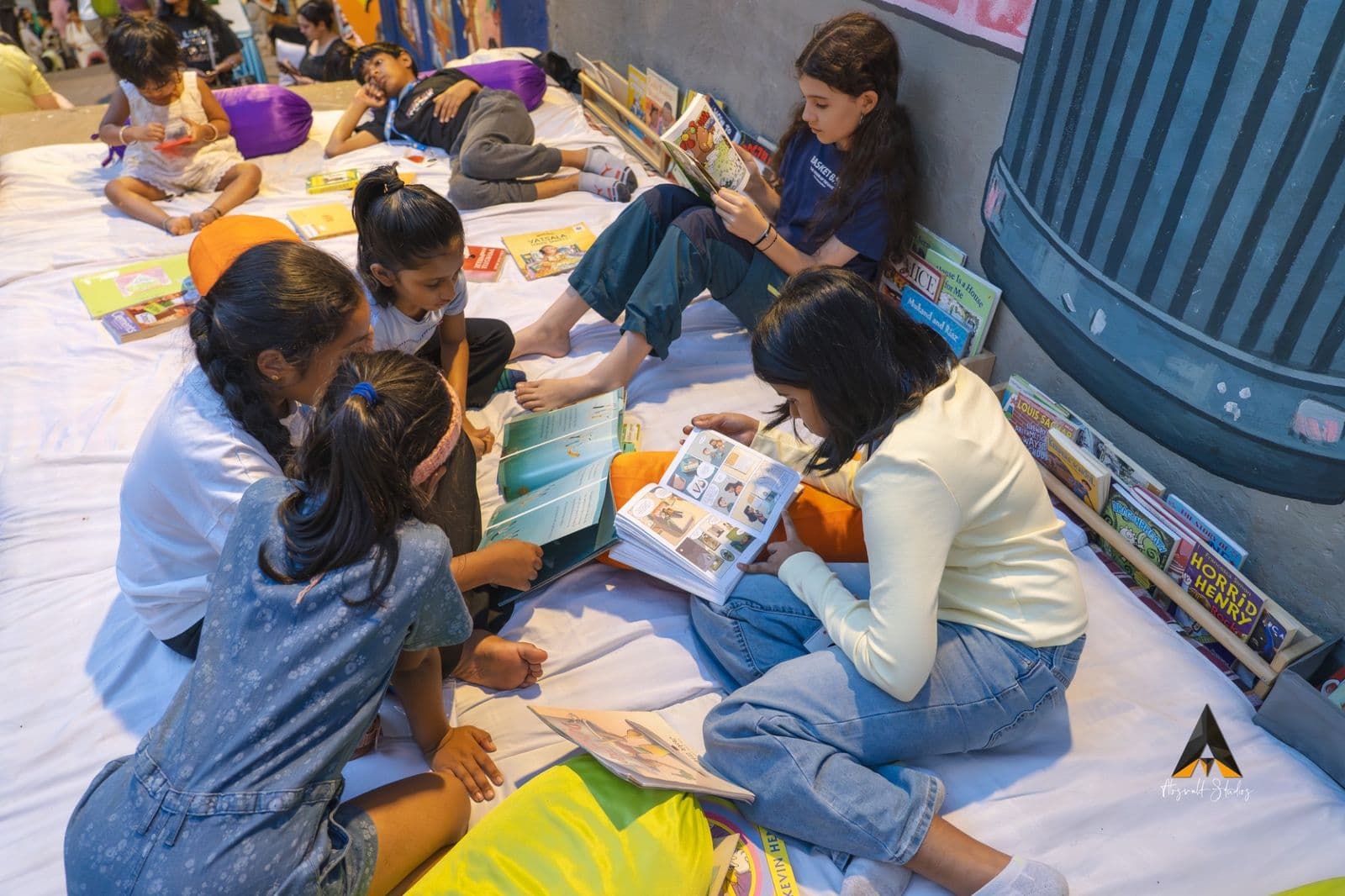 Children sprawled on floor cushions reading at a Lightship reading space
